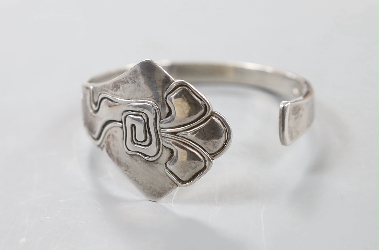 An early 20th century Danish sterling openwork bangle, dated for 1911, with later engraved inscription, assay master Christian F. Heise.